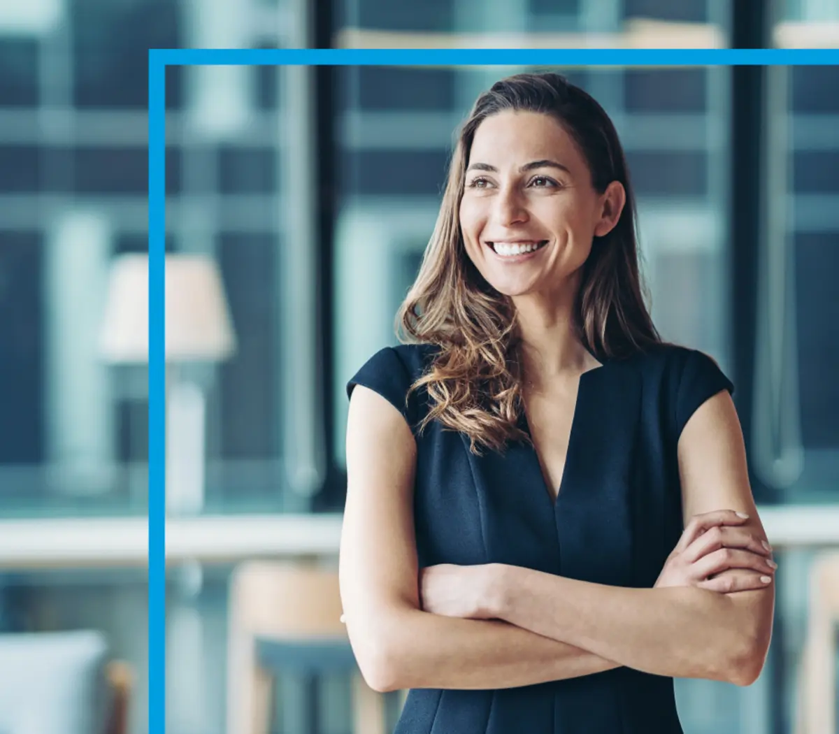 An asset manager in the Amundi offices, confidently posed with arms crossed.
