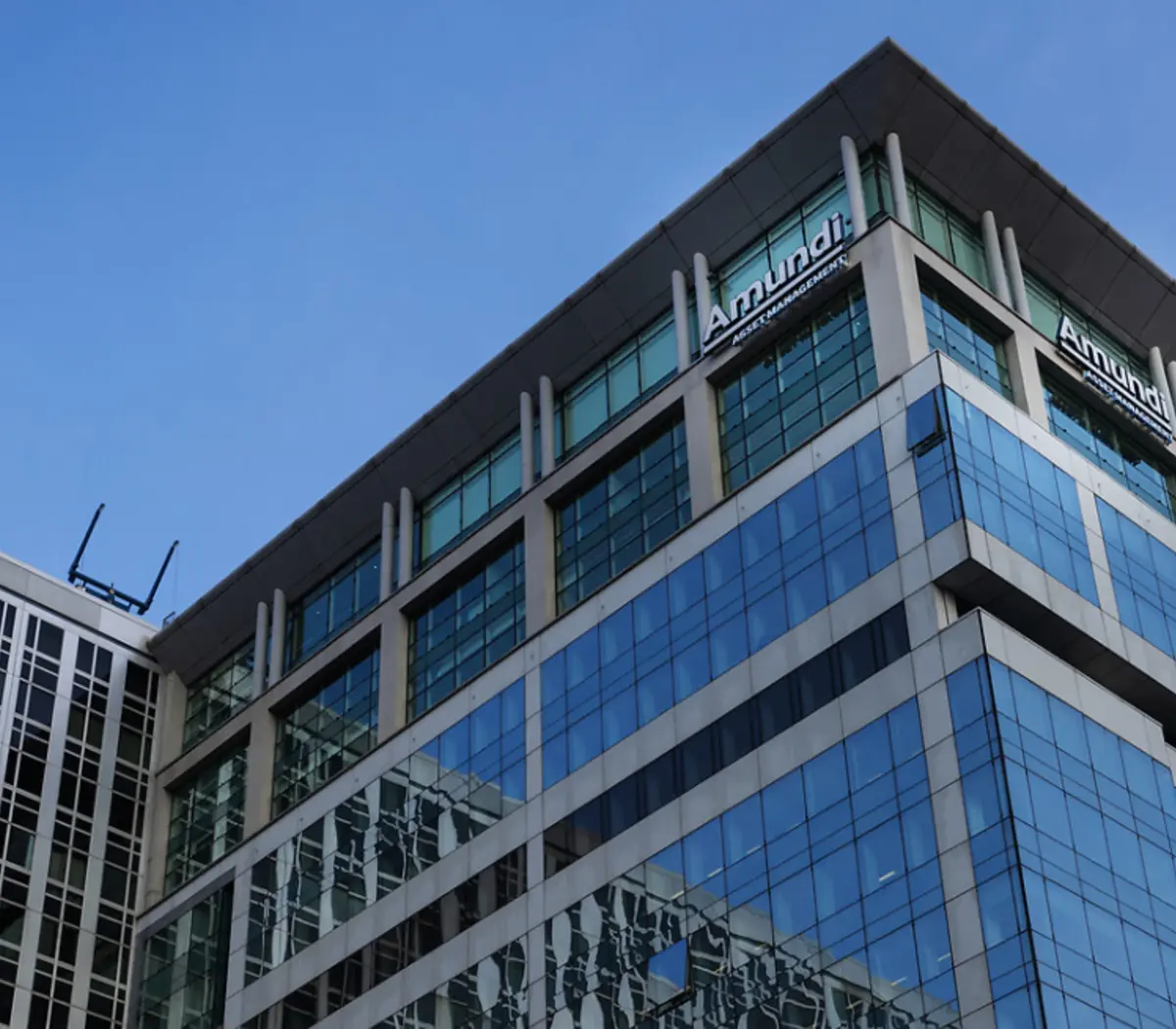 Modern glass office building representing Amundi's asset management presence.