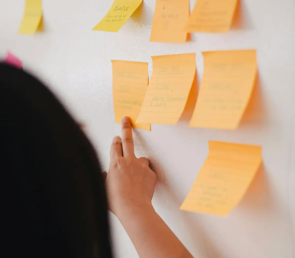 A financial expert reviews colorful sticky notes in the Amundi offices, focused on strategy.