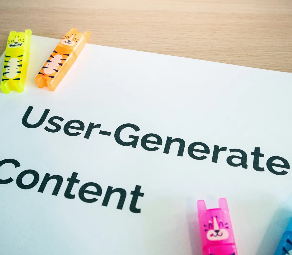 Colorful clips holding a paper titled "User-Generated Content" on a desk in an office.