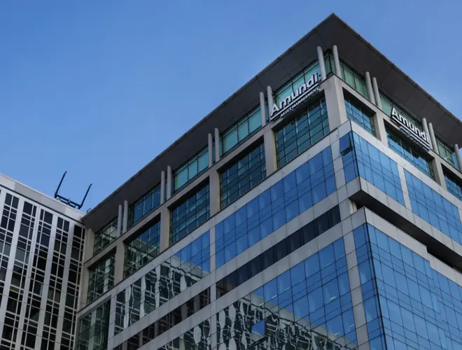 Modern glass office building representing Amundi's asset management presence.