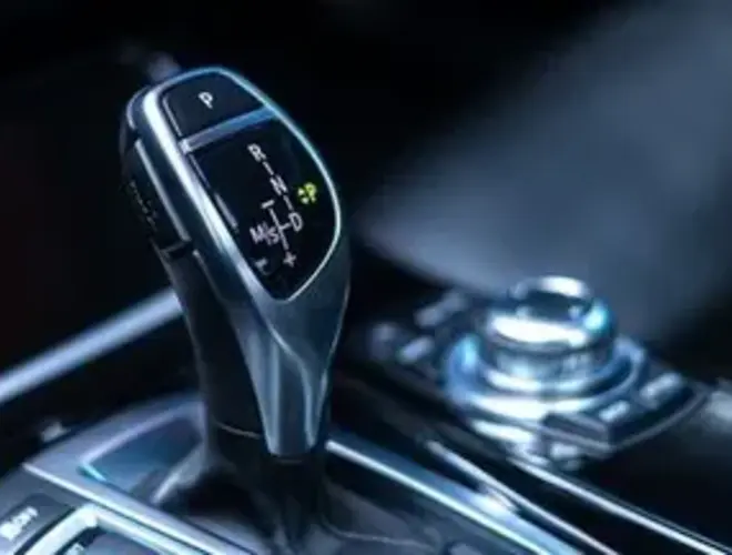 This image features a car gear shift, emphasizing sleek design and advanced technology.