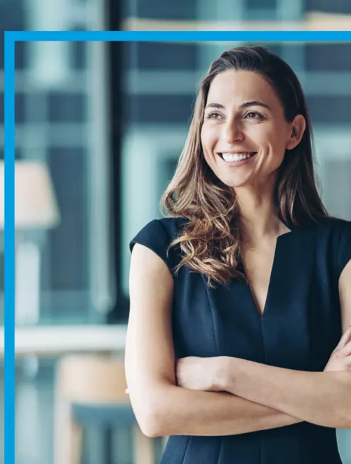 An asset manager in the Amundi offices, confidently posed with arms crossed.