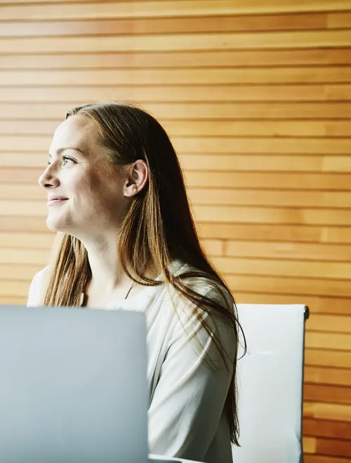 Asset manager working at a desk in Amundi offices, focused on financial analysis.
