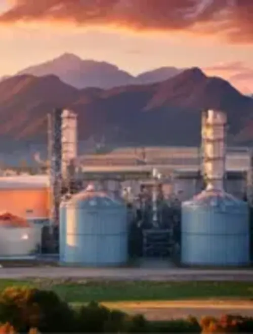 Industrial facilities against a sunset backdrop, highlighting investment opportunities in energy.