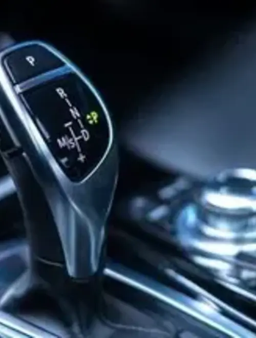 This image features a car gear shift, emphasizing sleek design and advanced technology.