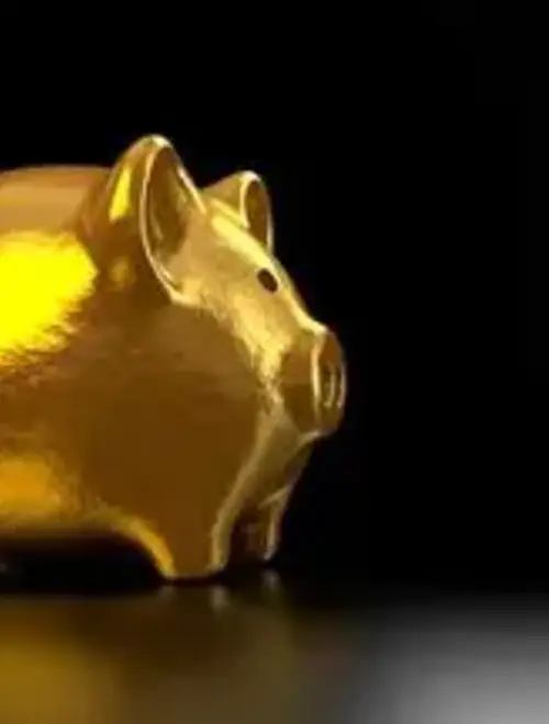 Golden piggy bank on a dark background, symbolizing savings and investment management.