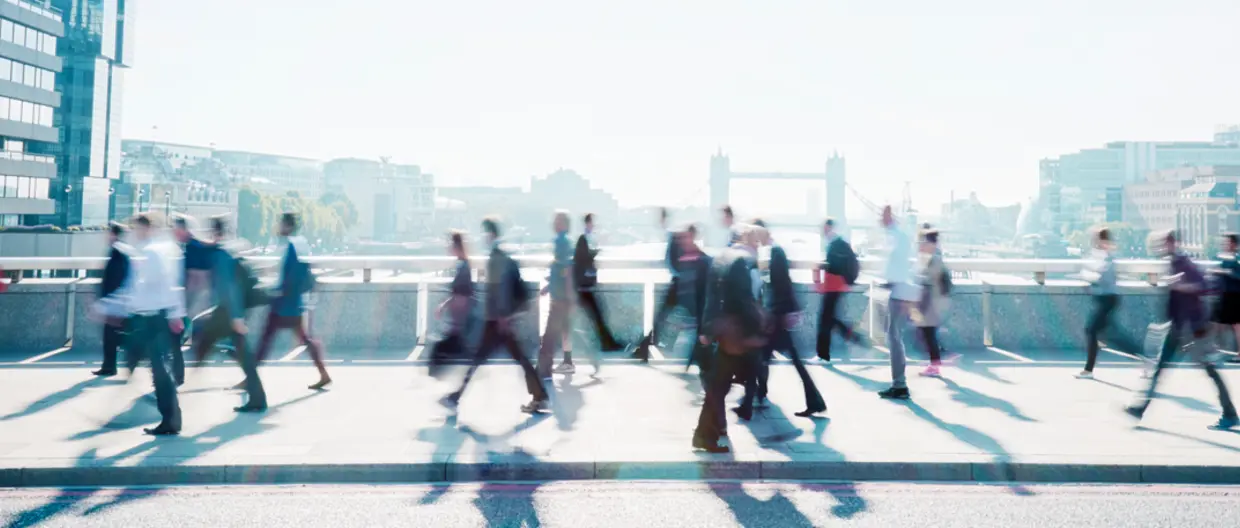 People walking by on a bridge in London