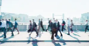 People walking by on a bridge in London
